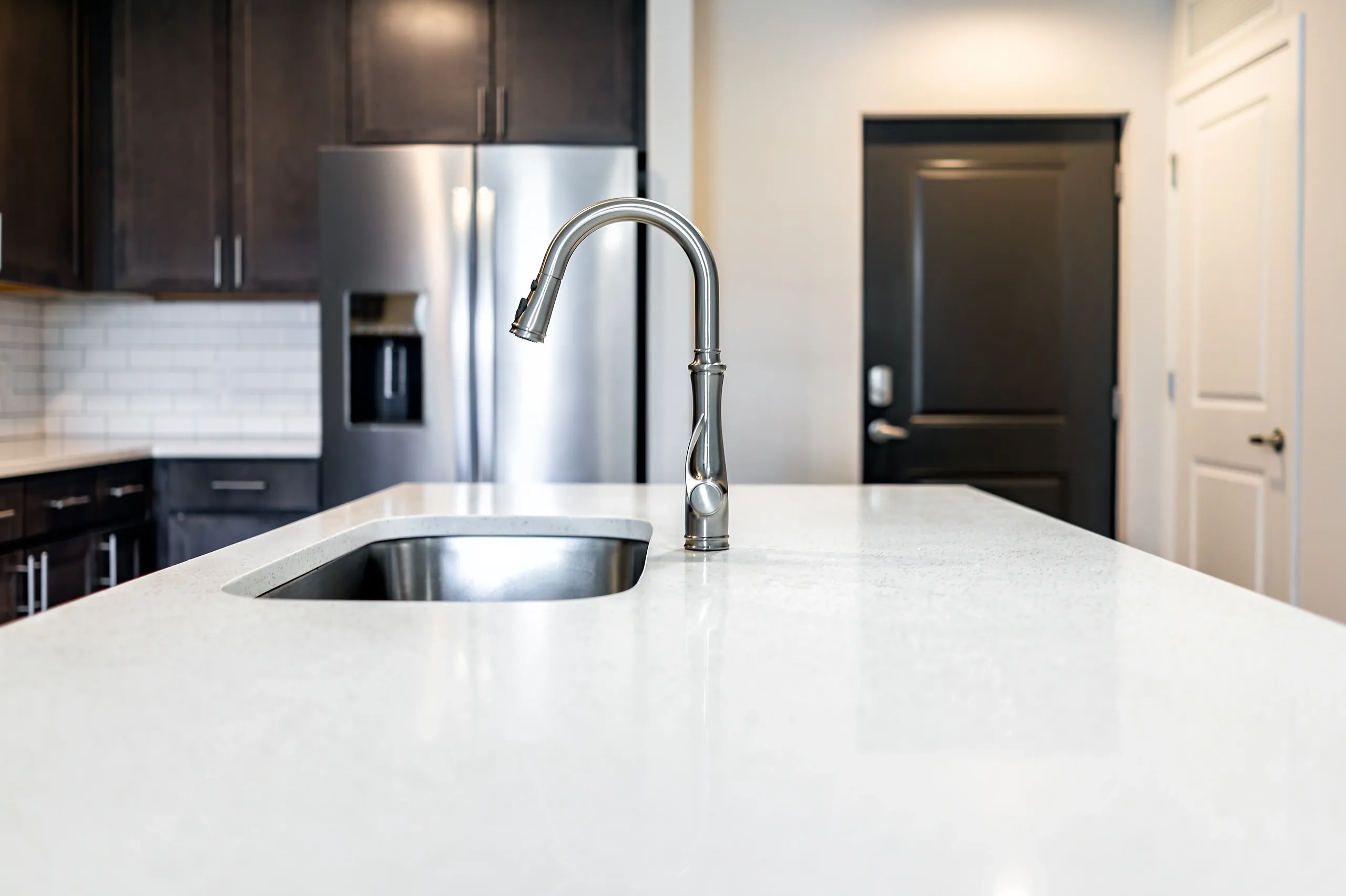 Modern kitchen remodel with white cabinets and quartz countertops